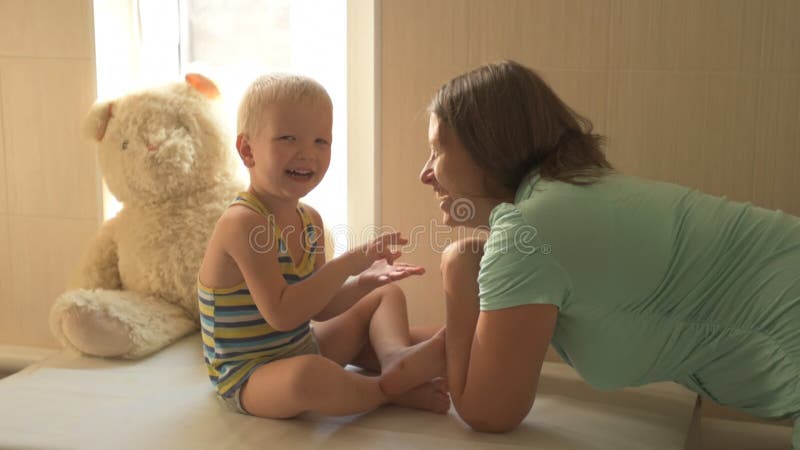 La giovane madre felice sta giocando con il suo bello ragazzino Carezza del bambino, baciare, abbracciante, civetteria Il bambino video d archivio La giovane madre felice sta giocando con il suo bello ragazzino Carezza del bambino, baciare, abbracciante, civetteria Il bambino video d archivio