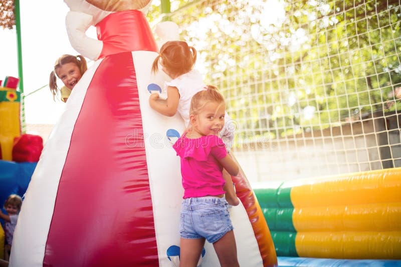 Sister is always there as support and help. Three little girl playing together on playground. Sister is always there as support and help. Three little girl playing together on playground.