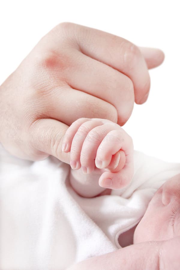 Colour photograph of a newborn childing holding fathers finger. Colour photograph of a newborn childing holding fathers finger