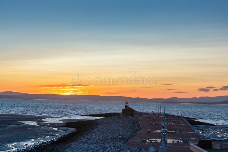 La jetée et le phare en pierre à Morecambe à l'aube images libres de droits La jetée et le phare en pierre à Morecambe à l'aube images libres de droits
