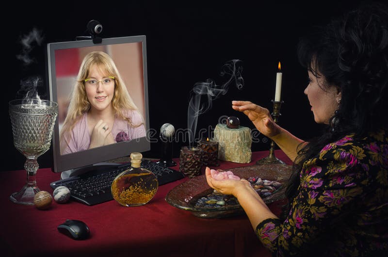 Fortuneteller teaches young blonde girl how to attract love with rose quartz during on-line video session. This psychic uses semi-precocious gemstones for prediction. Simple longhaired girl looks intently to mature clairvoyant. Horizontal indoors shot on black background. Fortuneteller teaches young blonde girl how to attract love with rose quartz during on-line video session. This psychic uses semi-precocious gemstones for prediction. Simple longhaired girl looks intently to mature clairvoyant. Horizontal indoors shot on black background