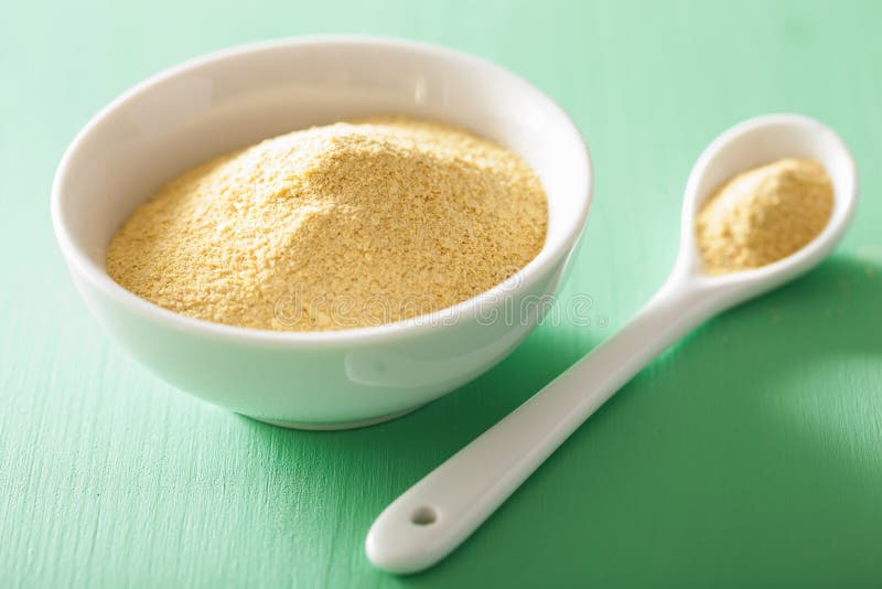 Vegan nutritional yeast flakes in bowl. Vegan nutritional yeast flakes in bowl.