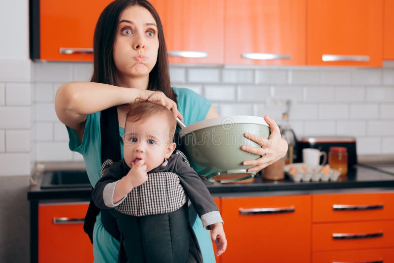 Mom making cookies carrying newborn around the kitchen. Mom making cookies carrying newborn around the kitchen