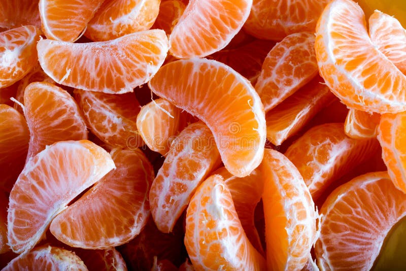 Tangerine or mandarin orange segments peeled close up background texture. Tangerine or mandarin orange segments peeled close up background texture.