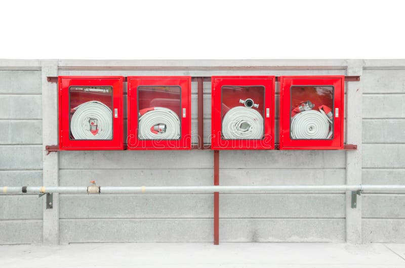 Emergency fire hose inside a glass fronted box mounted on a wall attached to a metal hydrant to provide water flow and pressure in an emergency. Emergency fire hose inside a glass fronted box mounted on a wall attached to a metal hydrant to provide water flow and pressure in an emergency