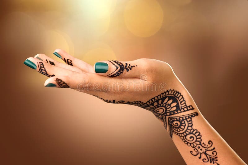 Woman's hand with mehndi tattoo. Hand of Indian bride with black henna tattoos. Woman's hand with mehndi tattoo. Hand of Indian bride with black henna tattoos