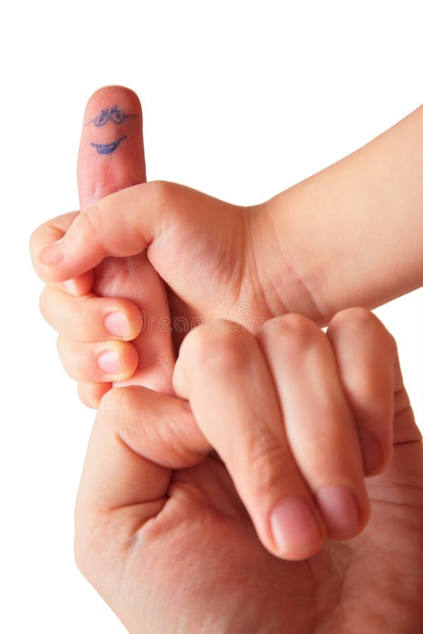 Children's hand holds finger with drawn face. Children's hand holds finger with drawn face