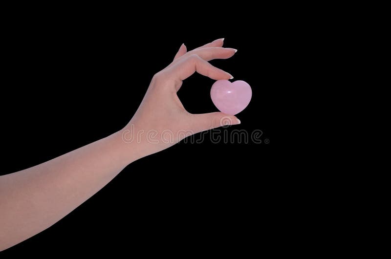 La mano della donna che tiene il cuore di Rose Quartz immagini stock libere da diritti La mano della donna che tiene il cuore di Rose Quartz immagini stock libere da diritti