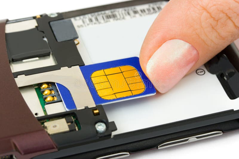 La mano instala la tarjeta del sim al teléfono móvil foto de archivo libre de regalías La mano instala la tarjeta del sim al teléfono móvil foto de archivo libre de regalías