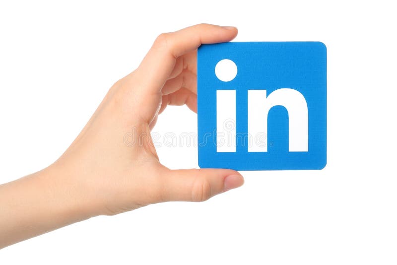 La mano lleva a cabo la muestra del logotipo de Linkedin impresa en el documento sobre el fondo blanco foto de archivo libre de regalías La mano lleva a cabo la muestra del logotipo de Linkedin impresa en el documento sobre el fondo blanco foto de archivo libre de regalías