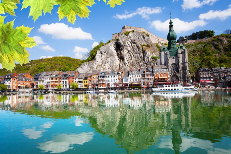 Meuse river with Collegiale Notre Dame, Citadelle de Dinant with white ship in Belgium. Meuse river with Collegiale Notre Dame, Citadelle de Dinant with white ship in Belgium.