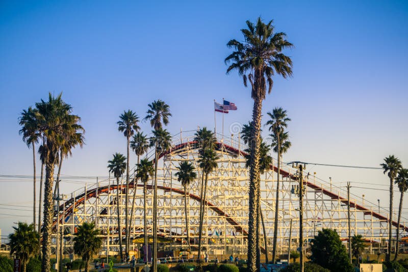 July 8, 2017 Santa Cruz/CA/USA - The Giant Dipper Roller coaster in Santa Cruz Beach Boardwalk amusement park at sunset, California. July 8, 2017 Santa Cruz/CA/USA - The Giant Dipper Roller coaster in Santa Cruz Beach Boardwalk amusement park at sunset, California