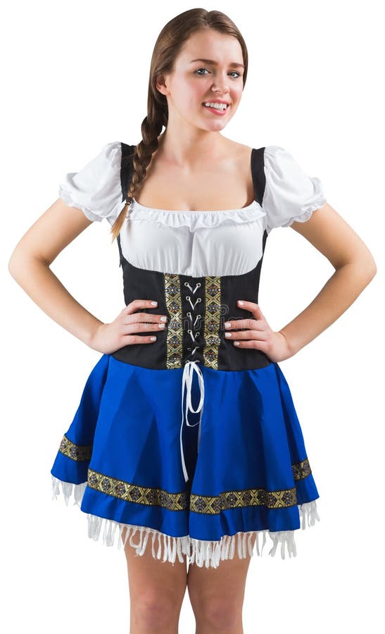 La muchacha bastante más oktoberfest con las manos en caderas imagen de archivo libre de regalías La muchacha bastante más oktoberfest con las manos en caderas imagen de archivo libre de regalías