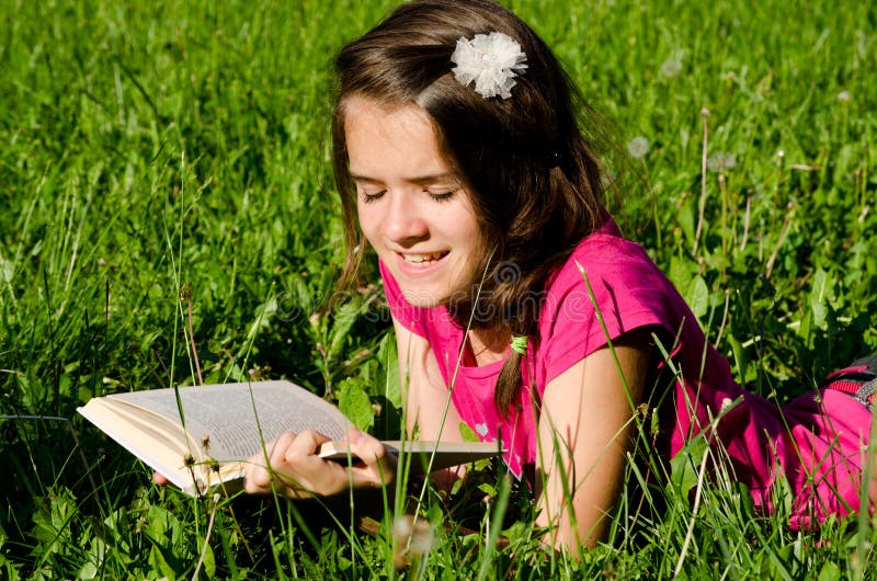 Teenager girl enjoy reading a book in summer field. Teenager girl enjoy reading a book in summer field
