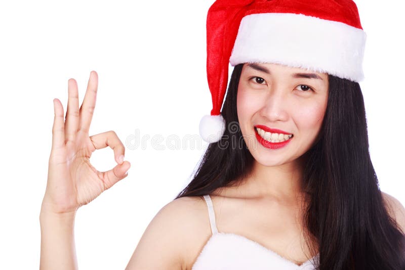 La mujer en Santa Claus roja viste mostrar la muestra aceptable aislada en whi fotos de archivo libres de regalías La mujer en Santa Claus roja viste mostrar la muestra aceptable aislada en whi fotos de archivo libres de regalías