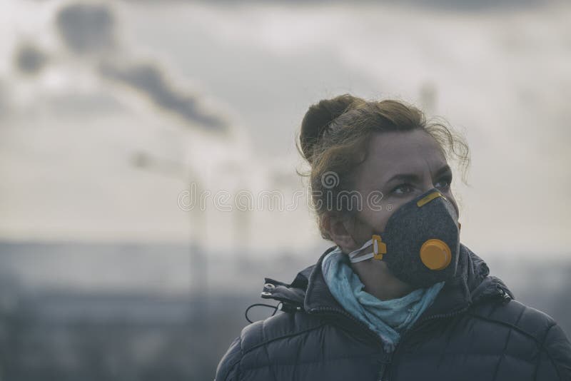 La mujer que lleva un anticontaminación real, contra la niebla y los virus la mascarilla fotografía de archivo libre de regalías La mujer que lleva un anticontaminación real, contra la niebla y los virus la mascarilla fotografía de archivo libre de regalías