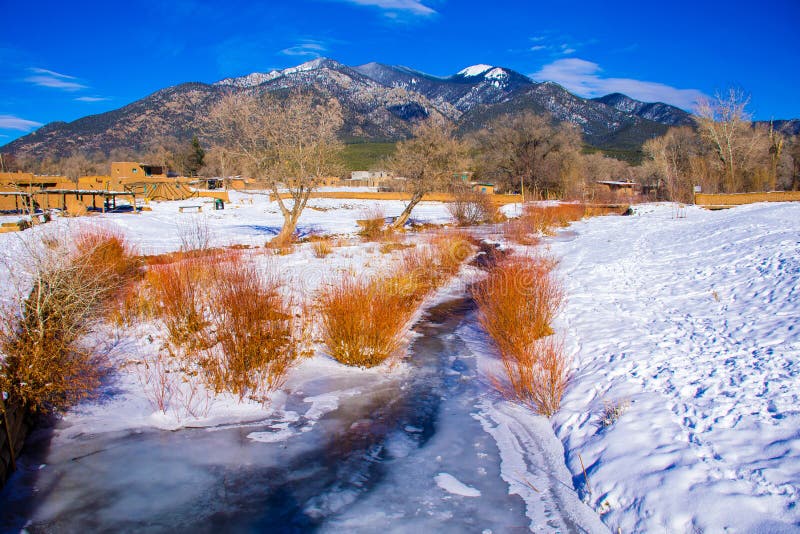 In Taos New Mexico with Snow covering the ground. This Valley Red River MountainScape this is a gorgeous valley in northern New mexico this river runs along some of the most natural lands in all of America. In Taos New Mexico with Snow covering the ground. This Valley Red River MountainScape this is a gorgeous valley in northern New mexico this river runs along some of the most natural lands in all of America.