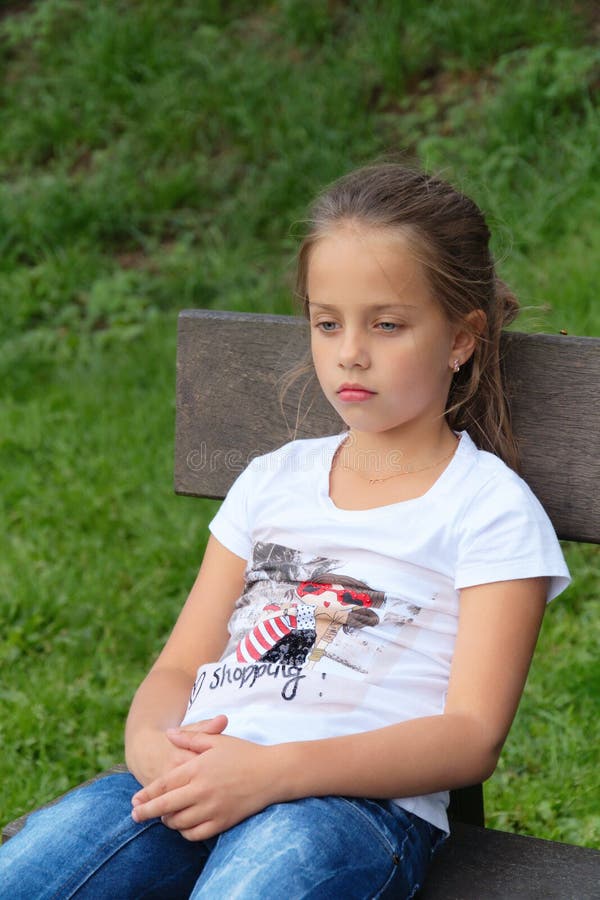La niña triste piensa la mirada abajo, en banco imágenes de archivo libres de regalías La niña triste piensa la mirada abajo, en banco imágenes de archivo libres de regalías