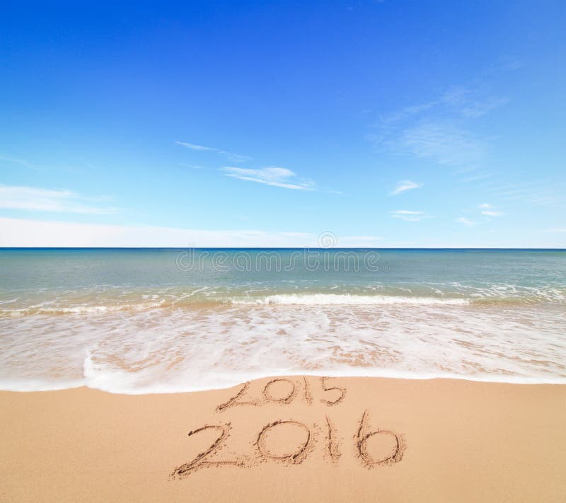 New Year 2016 is coming concept - inscription 2015 and 2016 on a beach sand, the wave is covering digits 2015. New Year 2016 is coming concept - inscription 2015 and 2016 on a beach sand, the wave is covering digits 2015