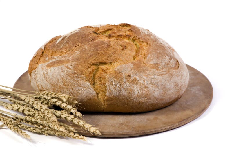 A crusted loaf of italian bread fresh from the oven with several stalks of wheat beside it. A crusted loaf of italian bread fresh from the oven with several stalks of wheat beside it.