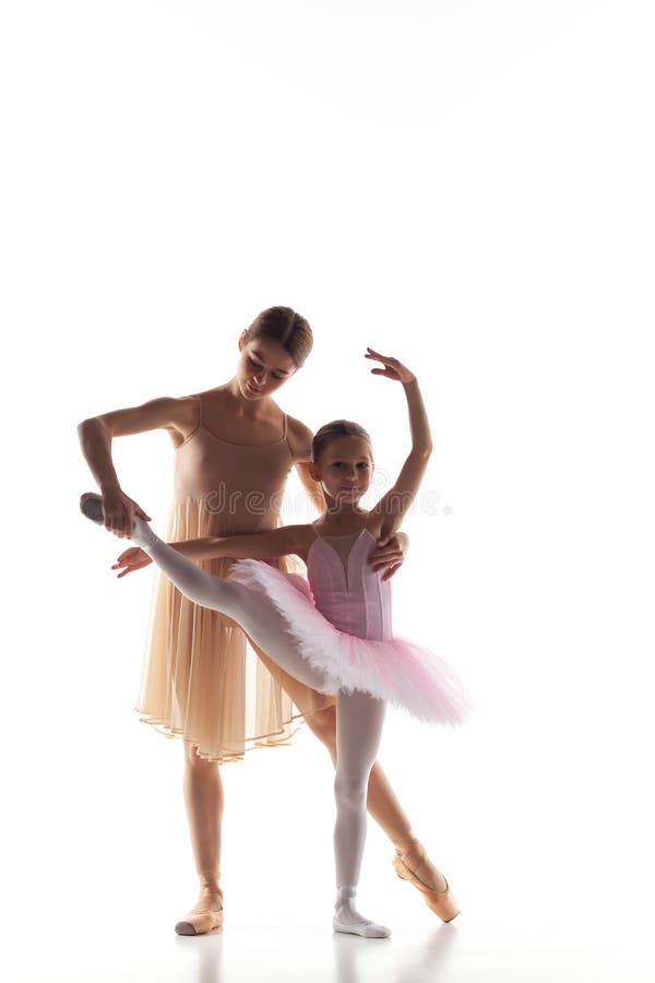 La petite danse de ballerine avec le professeur personnel de ballet dans le studio de danse image stock La petite danse de ballerine avec le professeur personnel de ballet dans le studio de danse image stock