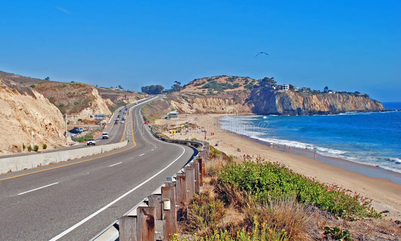 Photo shows Coast Highway passing by the El Moro State Park campground (left) and Crystal Cove region (right) halfway between Corona Del Mar and Laguna Beach. Abalone Point is the prominent cliff formation at upper right. Photo shows Coast Highway passing by the El Moro State Park campground (left) and Crystal Cove region (right) halfway between Corona Del Mar and Laguna Beach. Abalone Point is the prominent cliff formation at upper right.