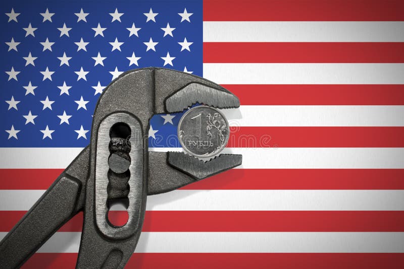 La pièce de monnaie dans l'étau sur le fond du drapeau des Etats-Unis photo stock La pièce de monnaie dans l'étau sur le fond du drapeau des Etats-Unis photo stock