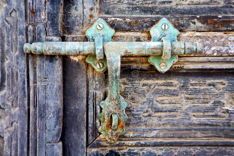 Door abstract spain canarias brass brown knocker in a green closed wood lanzarote. Door abstract spain canarias brass brown knocker in a green closed wood lanzarote