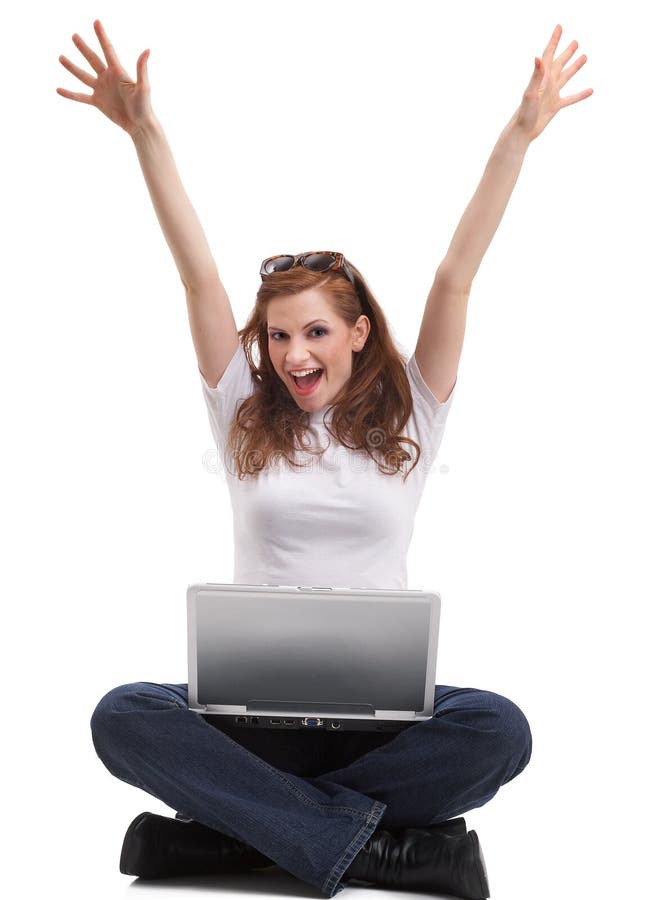 One young student is sitting on the floor with her laptop and rejoice. One young student is sitting on the floor with her laptop and rejoice