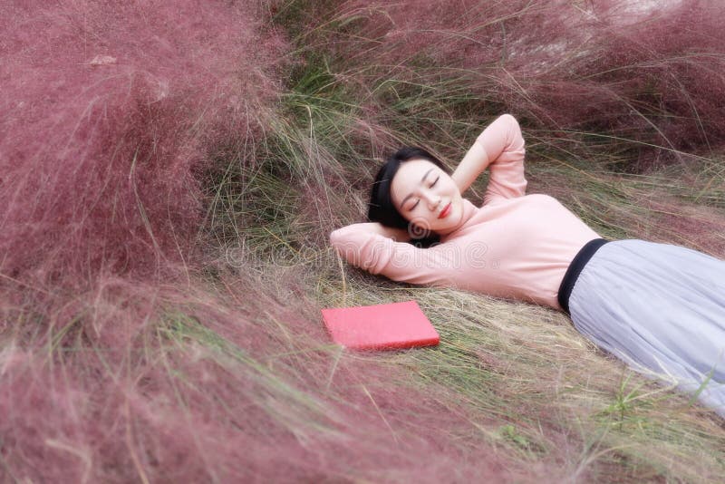 Pink colour grass lawn, rose hermosa, carnation . Pretty beautiful cute Asian Chinese woman girl reading book in a flower field outdoor in summer autumn fall park dreamlike garden. girl reads magic book.reading,summer,academic, alphabet,card,grass,homework,lawn learning letters,lying and sit on beach, outside , study in school. relaxing day. closed eyes and dream of sweet dream fairy, bible, education freedom god love learning concept. Pink colour grass lawn, rose hermosa, carnation . Pretty beautiful cute Asian Chinese woman girl reading book in a flower field outdoor in summer autumn fall park dreamlike garden. girl reads magic book.reading,summer,academic, alphabet,card,grass,homework,lawn learning letters,lying and sit on beach, outside , study in school. relaxing day. closed eyes and dream of sweet dream fairy, bible, education freedom god love learning concept