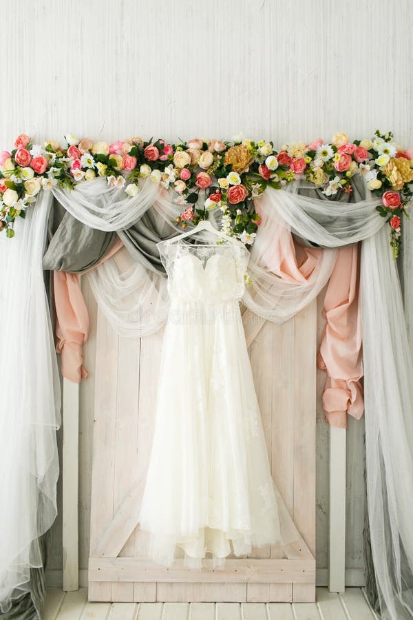 La robe de la jeune mariée accroche sur une voûte l'épousant photos stock La robe de la jeune mariée accroche sur une voûte l'épousant photos stock