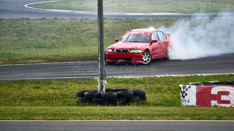 Russia Ryazan International Track Atron September 2020. A sports car in a controlled skid on the track. Smoke billows from under the wheels. Russia Ryazan International Track Atron September 2020. A sports car in a controlled skid on the track. Smoke billows from under the wheels