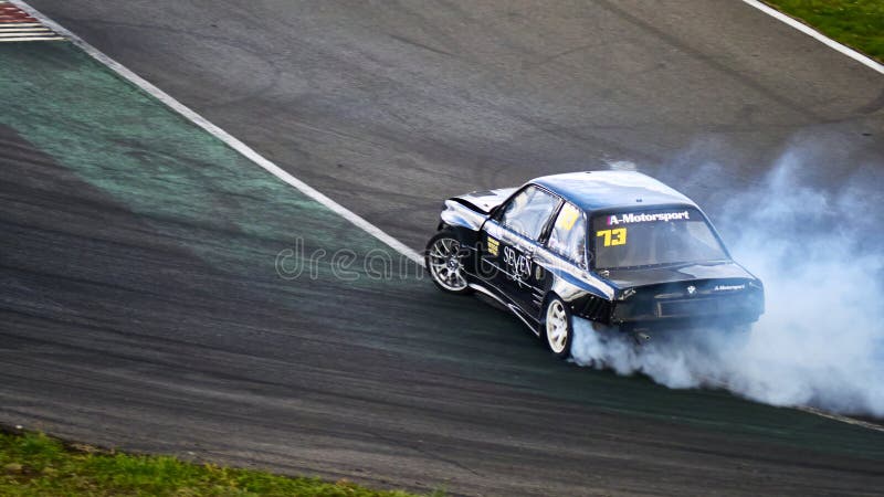 Russia Ryazan International Track Atron September 2020. A sports car in a controlled skid on the track. Smoke billows from under the wheels. Russia Ryazan International Track Atron September 2020. A sports car in a controlled skid on the track. Smoke billows from under the wheels