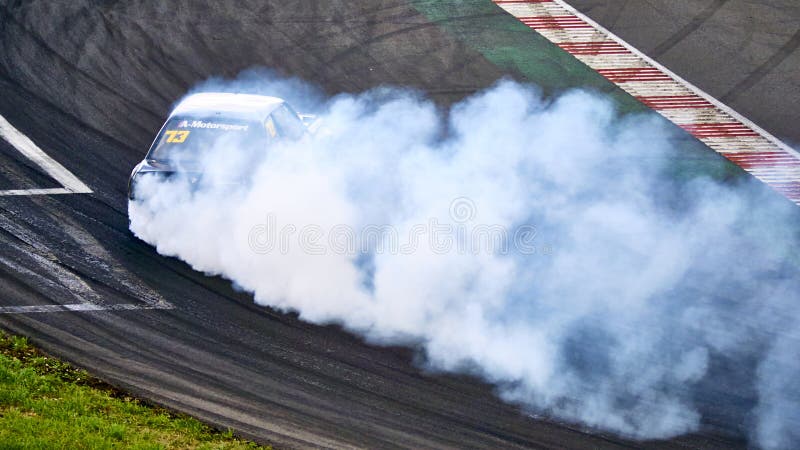 Russia Ryazan International Track Atron September 2020. A sports car in a controlled skid on the track. Smoke billows from under the wheels. Russia Ryazan International Track Atron September 2020. A sports car in a controlled skid on the track. Smoke billows from under the wheels