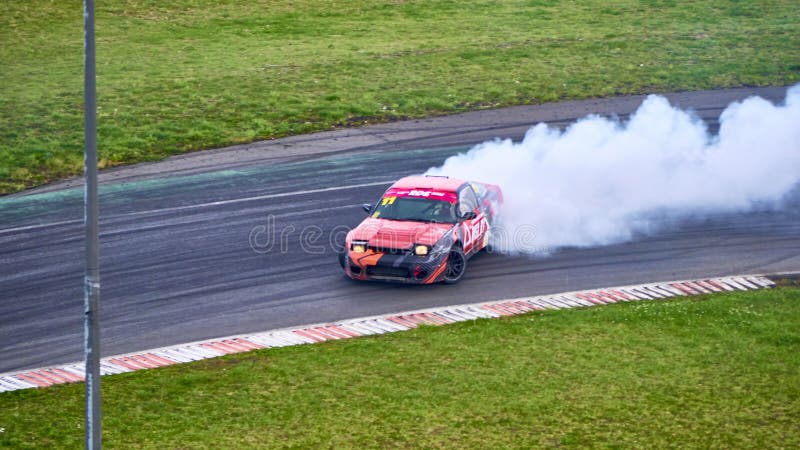 Russia Ryazan International Track Atron September 2020. A sports car in a controlled skid on the track. Smoke billows from under the wheels. Russia Ryazan International Track Atron September 2020. A sports car in a controlled skid on the track. Smoke billows from under the wheels
