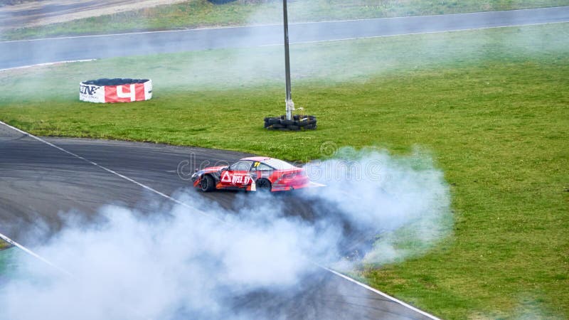 Russia Ryazan International Track Atron September 2020. A sports car in a controlled skid on the track. Smoke billows from under the wheels. Russia Ryazan International Track Atron September 2020. A sports car in a controlled skid on the track. Smoke billows from under the wheels