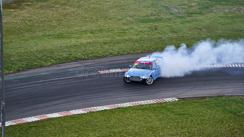 Russia Ryazan International Track Atron September 2020. A sports car in a controlled skid on the track. Smoke billows from under the wheels. Russia Ryazan International Track Atron September 2020. A sports car in a controlled skid on the track. Smoke billows from under the wheels