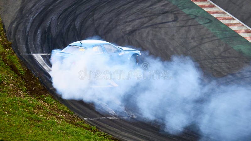 Russia Ryazan International Track Atron September 2020. A sports car in a controlled skid on the track. Smoke billows from under the wheels. Russia Ryazan International Track Atron September 2020. A sports car in a controlled skid on the track. Smoke billows from under the wheels