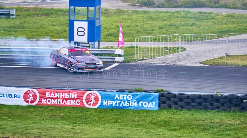 Russia Ryazan International Track Atron September 2020. A sports car in a controlled skid on the track. Smoke billows from under the wheels. Russia Ryazan International Track Atron September 2020. A sports car in a controlled skid on the track. Smoke billows from under the wheels