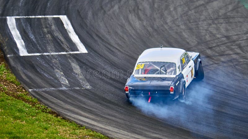 Russia Ryazan International Track Atron September 2020. A sports car in a controlled skid on the track. Smoke billows from under the wheels. Russia Ryazan International Track Atron September 2020. A sports car in a controlled skid on the track. Smoke billows from under the wheels