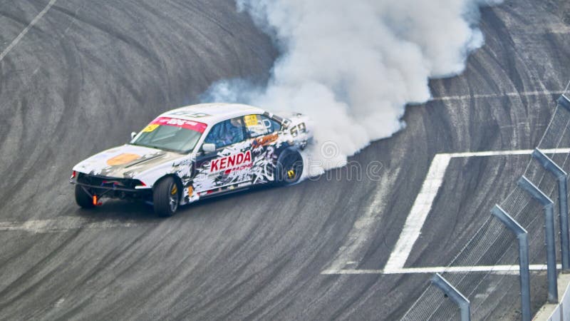 Russia Ryazan International Track Atron September 2020. A sports car in a controlled skid on the track. Smoke billows from under the wheels. Russia Ryazan International Track Atron September 2020. A sports car in a controlled skid on the track. Smoke billows from under the wheels