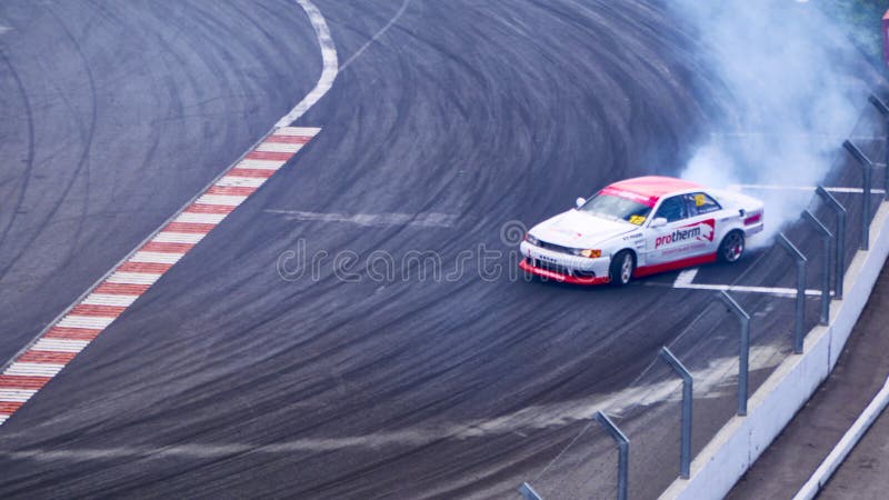 Russia Ryazan International Track Atron September 2020. A sports car in a controlled skid on the track. Smoke billows from under the wheels. Russia Ryazan International Track Atron September 2020. A sports car in a controlled skid on the track. Smoke billows from under the wheels