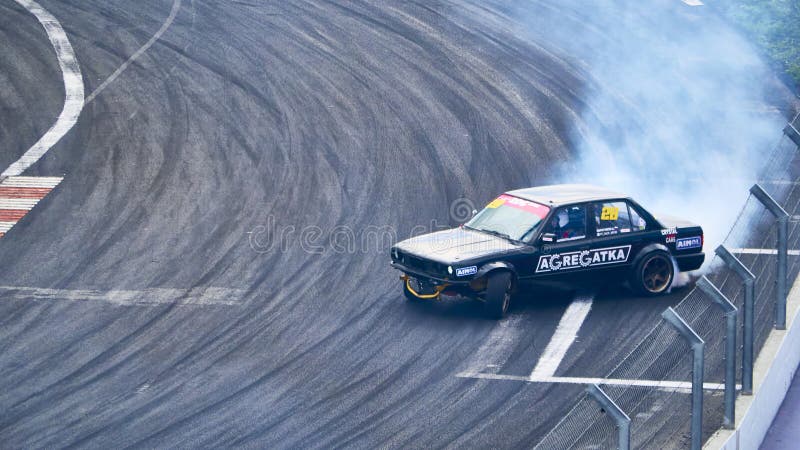 Russia Ryazan International Track Atron September 2020. A sports car in a controlled skid on the track. Smoke billows from under the wheels. Russia Ryazan International Track Atron September 2020. A sports car in a controlled skid on the track. Smoke billows from under the wheels