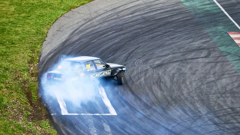 Russia Ryazan International Track Atron September 2020. A sports car in a controlled skid on the track. Smoke billows from under the wheels. Russia Ryazan International Track Atron September 2020. A sports car in a controlled skid on the track. Smoke billows from under the wheels