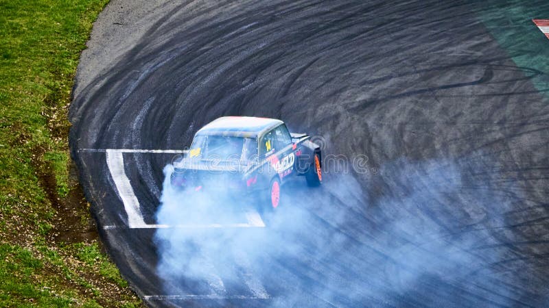 Russia Ryazan International Track Atron September 2020. A sports car in a controlled skid on the track. Smoke billows from under the wheels. Russia Ryazan International Track Atron September 2020. A sports car in a controlled skid on the track. Smoke billows from under the wheels