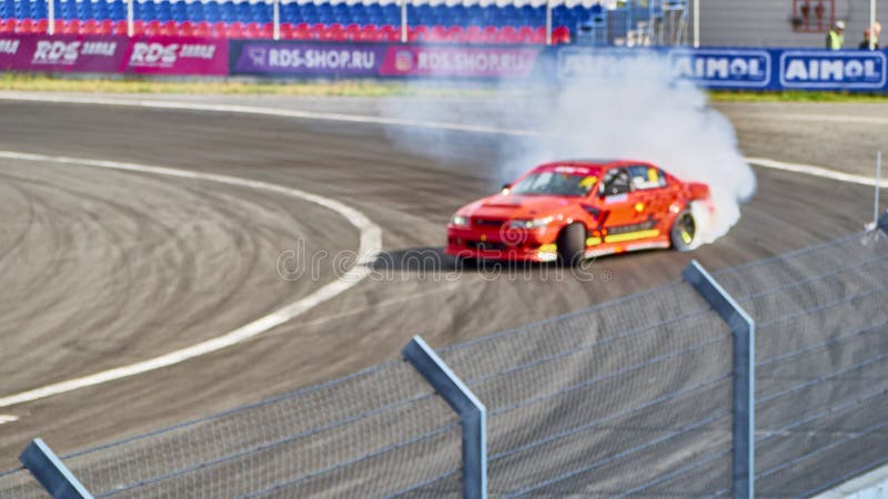 Russia Ryazan International Track Atron September 2020. A sports car in a controlled skid on the track. Smoke billows from under the wheels. Russia Ryazan International Track Atron September 2020. A sports car in a controlled skid on the track. Smoke billows from under the wheels