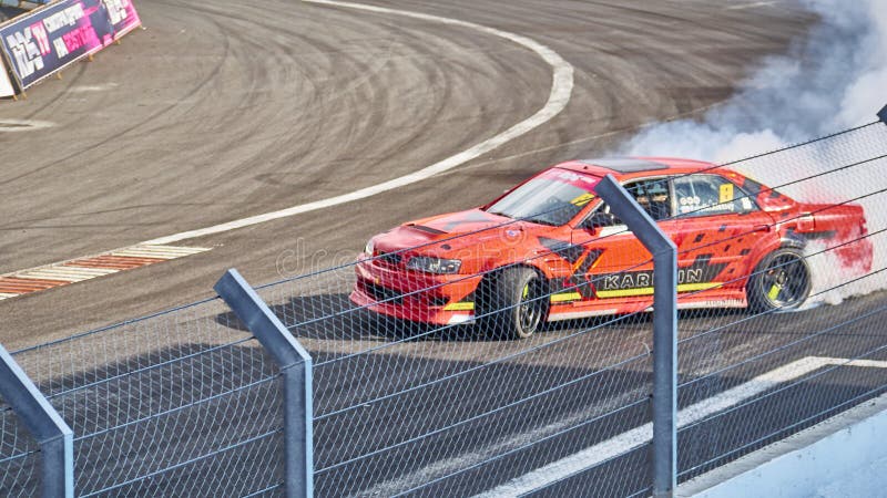 Russia Ryazan International Track Atron September 2020. A sports car in a controlled skid on the track. Smoke billows from under the wheels. Russia Ryazan International Track Atron September 2020. A sports car in a controlled skid on the track. Smoke billows from under the wheels