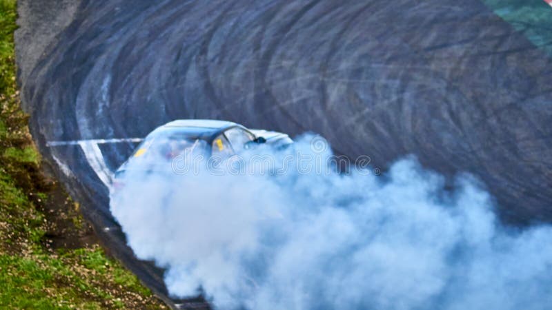 Russia Ryazan International Track Atron September 2020. A sports car in a controlled skid on the track. Smoke billows from under the wheels. Russia Ryazan International Track Atron September 2020. A sports car in a controlled skid on the track. Smoke billows from under the wheels