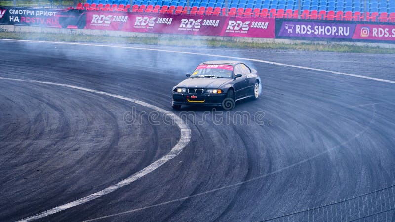 Russia Ryazan International Track Atron September 2020. A sports car in a controlled skid on the track. Smoke billows from under the wheels. Russia Ryazan International Track Atron September 2020. A sports car in a controlled skid on the track. Smoke billows from under the wheels