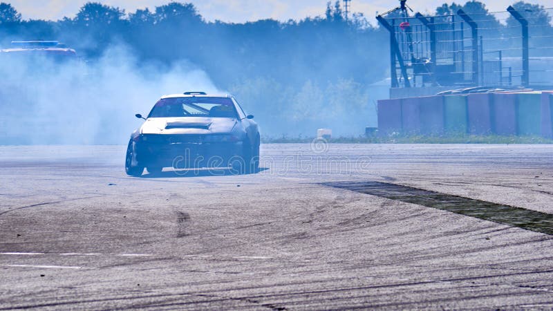 Russia Ryazan International Track Atron September 2020. A sports car in a controlled skid on the track. Smoke billows from under the wheels. Russia Ryazan International Track Atron September 2020. A sports car in a controlled skid on the track. Smoke billows from under the wheels